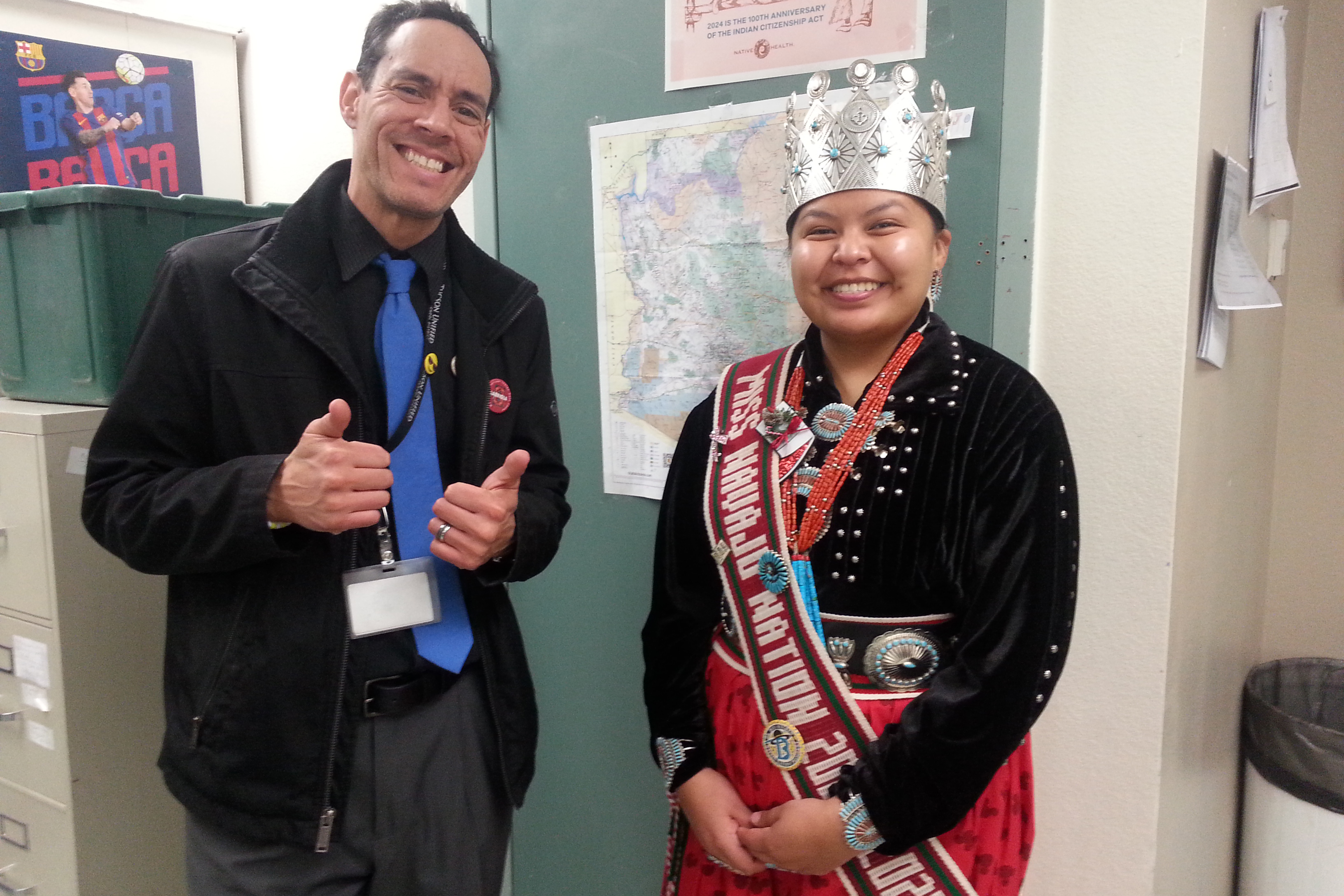 Miss Navajo Nation smiles for a photo with a male teacher