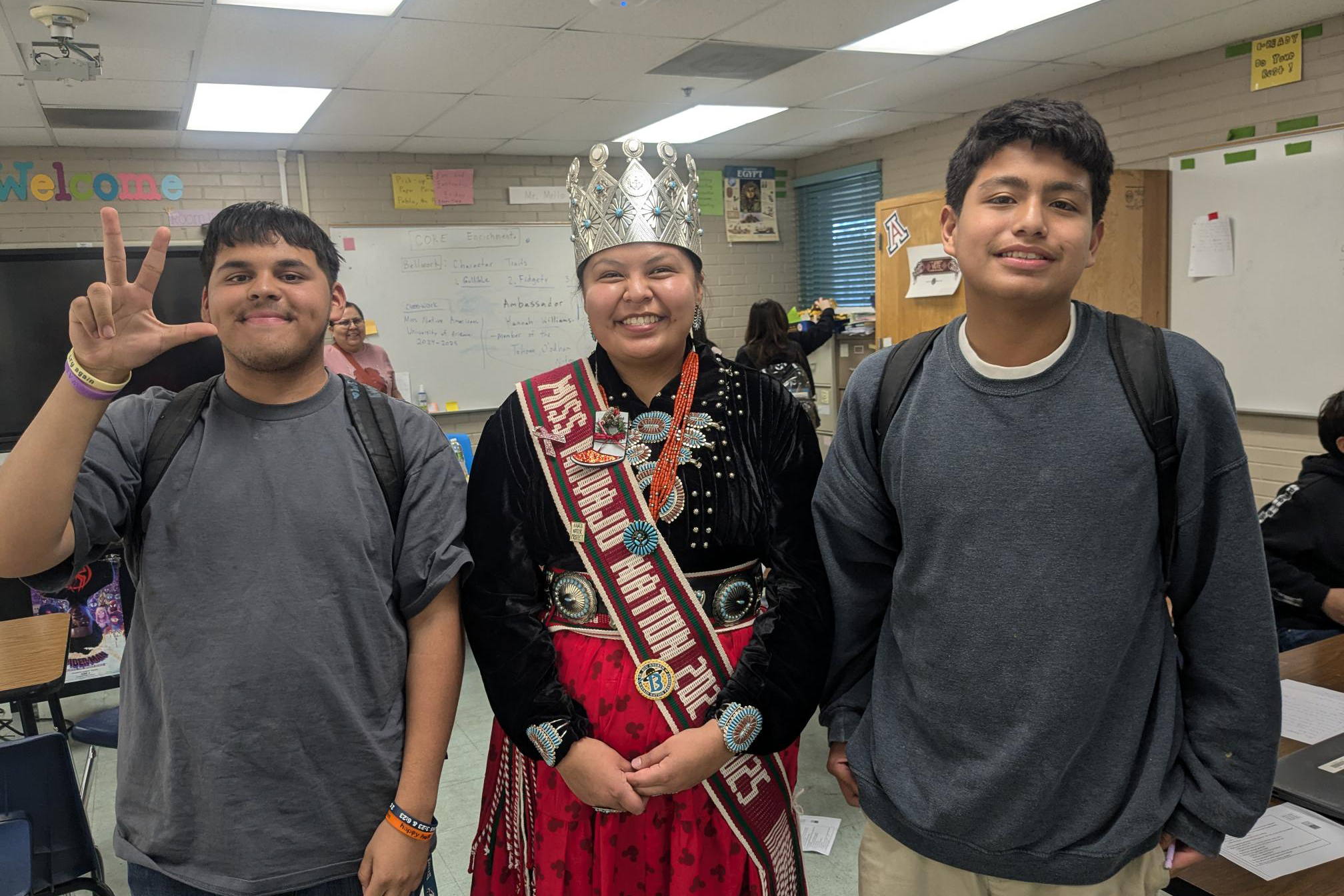 Miss Navajo Nation smiles for a photo with two teen boys